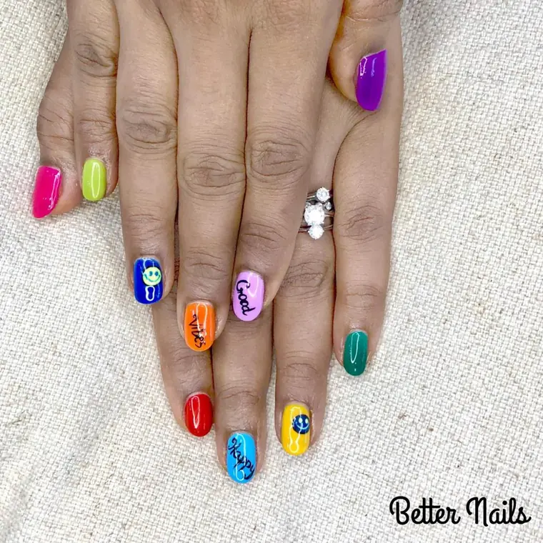 Multicoloured set with a different bright shade and a cartoon face on each nail